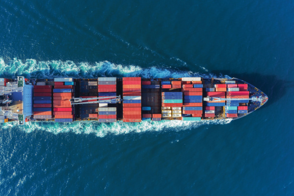 Cargo ship moving left to right across water
